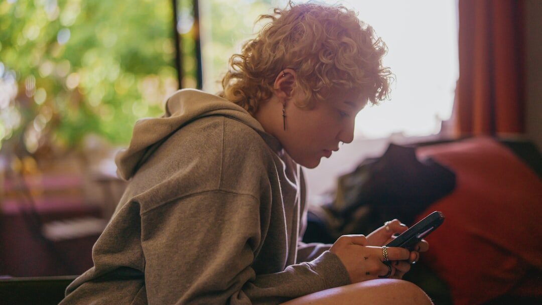 teenager watching celebrity on phone