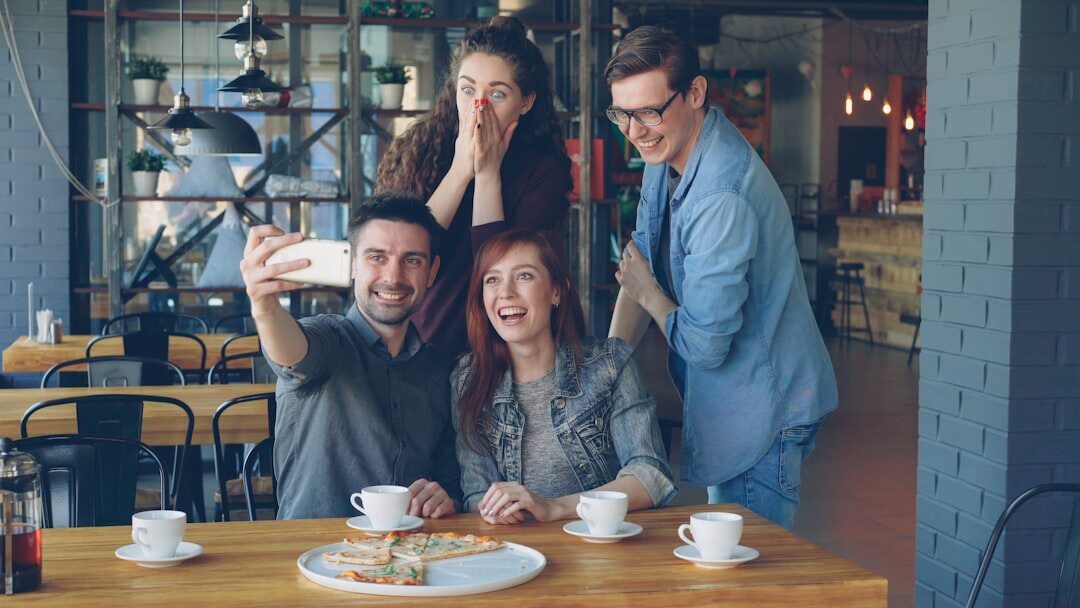 people using smartphones in cafe